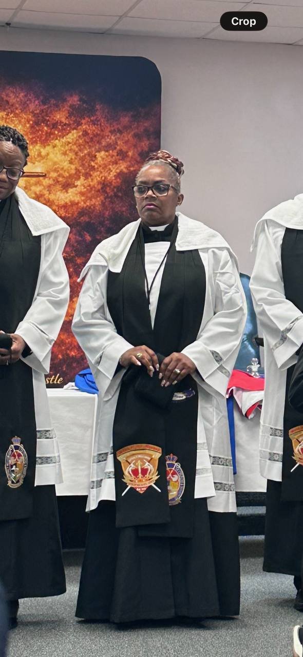 A clergy member in black and white ceremonial vestments
