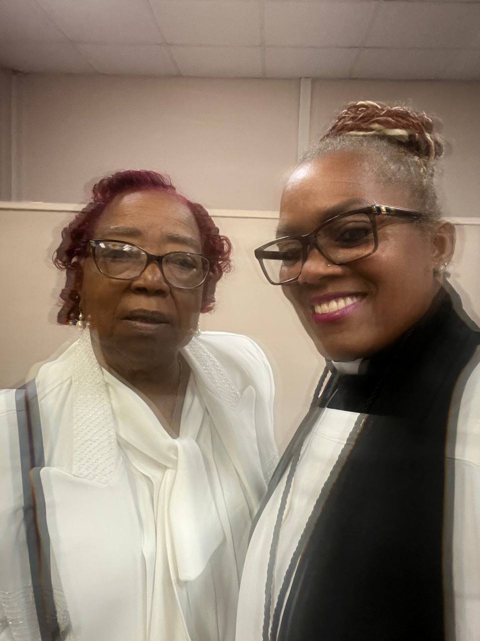 A minister standing beside a senior community member