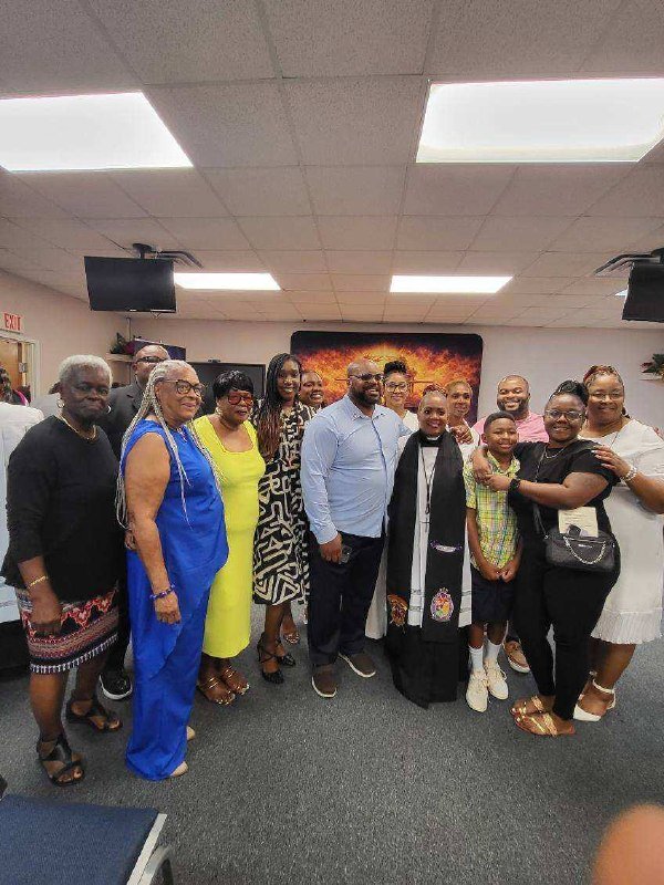 A group of ministry members and family gathered for a photograph